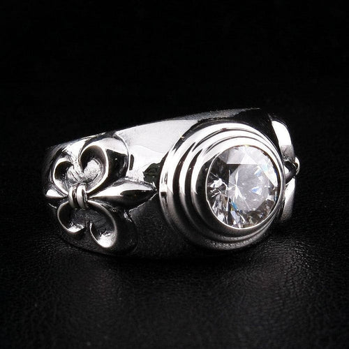 Side angle view of .925 sterling silver ring featuring Fleur De Lis motif and round-cut clear topaz gemstone