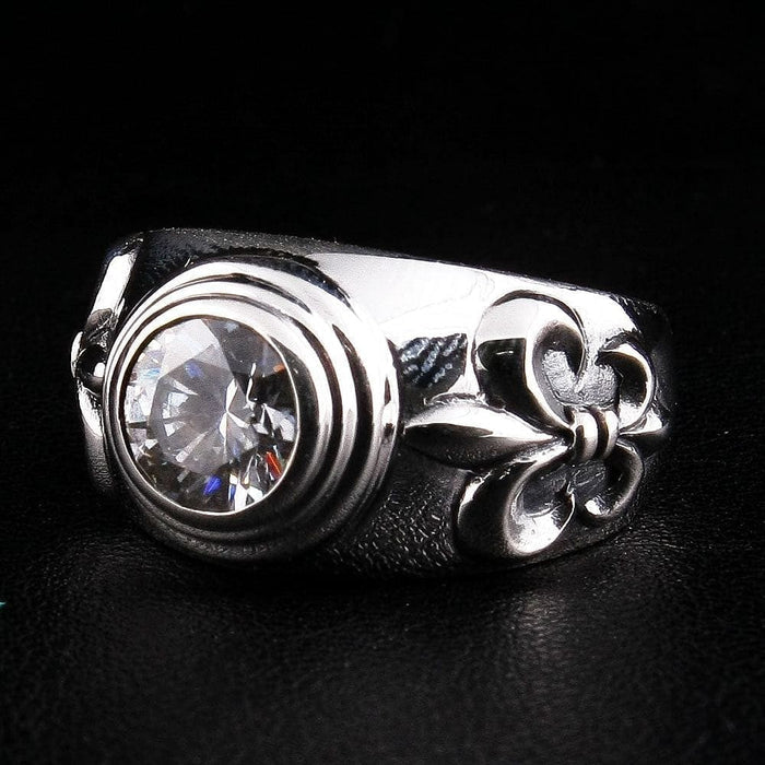 Right side detail of sterling silver Fleur De Lis ring showing topaz bezel setting and sculpted motif