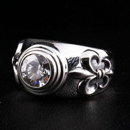 Right side detail of sterling silver Fleur De Lis ring showing topaz bezel setting and sculpted motif