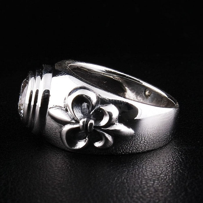 Back angle of .925 hallmarked sterling silver ring with Fleur De Lis design and topaz gemstone setting