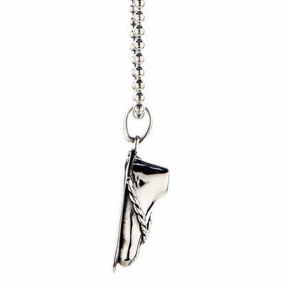 Sterling silver sandal charm pendant with braided detail, hanging from a ball chain, shown in a close-up side view on a white background