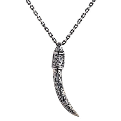 A solid sterling silver tusk pendant with an ornate cap featuring a beautifully detailed engraving of the Hindu god Ganesh.