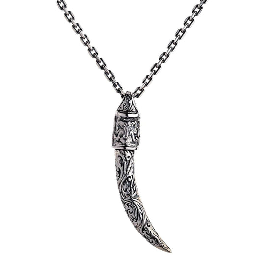 A solid sterling silver tusk pendant with an ornate cap featuring a beautifully detailed engraving of the Hindu god Ganesh.
