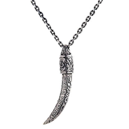 A premium sterling silver tusk pendant with "oriental vibrations" and intricate scrollwork engravings along its body.