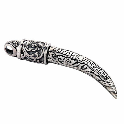 A beautifully handcrafted solid silver tusk pendant with a high-contrast polished and dark, oxidized finish.