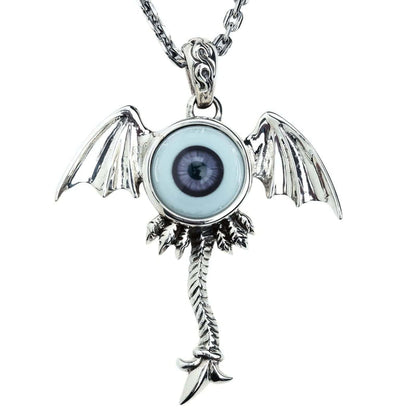 The surreal winged eyeball pendant in solid silver with a dark purple eye on a white background.