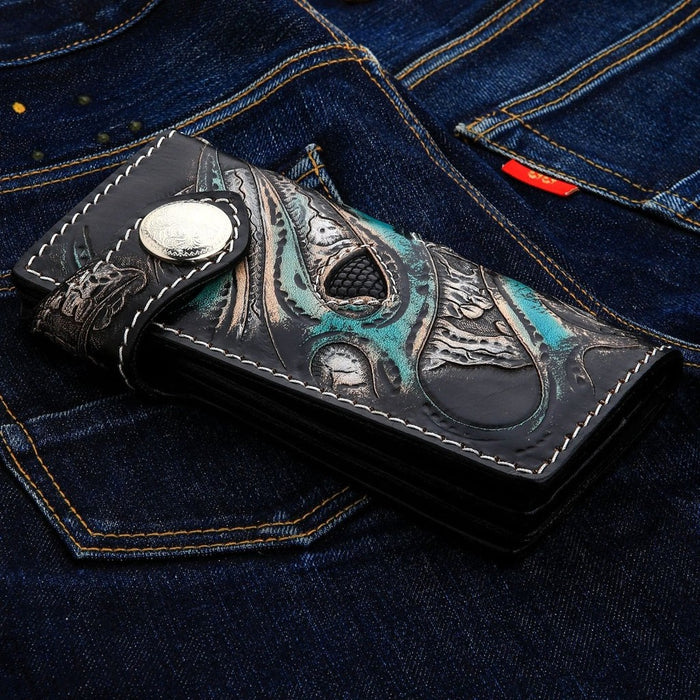 Close up of snap button closure on hand-carved leather skull wallet