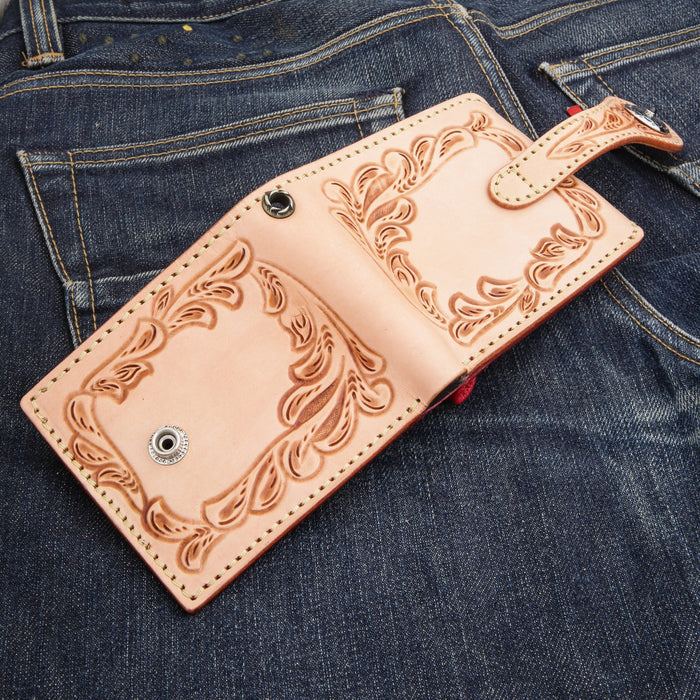 Interior laid flat showing the red leather coin pocket with a fold-over leather-loop flap
