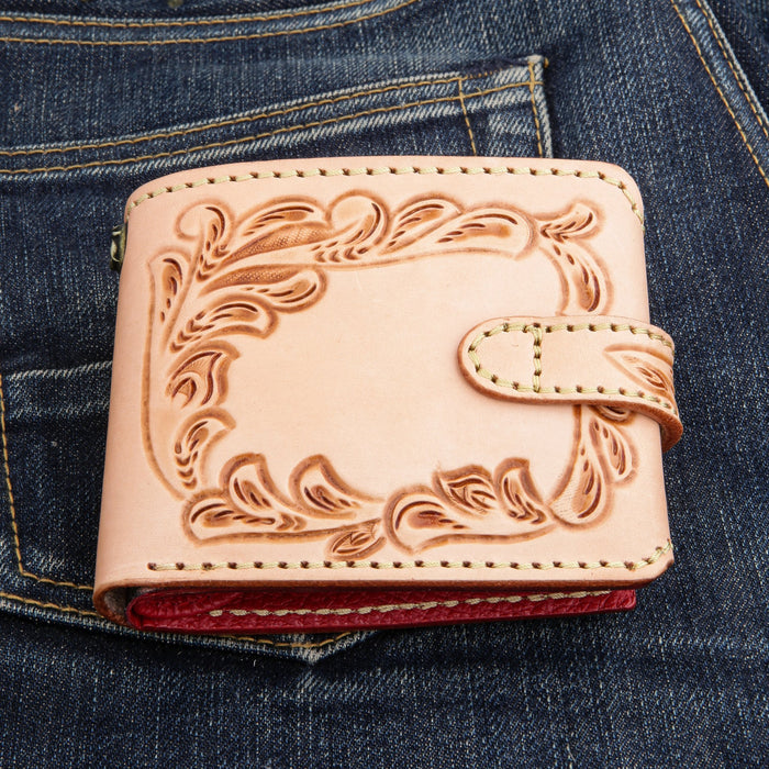 Back panel of the natural leather wallet with hand-carved floral tooling and cream saddle stitching