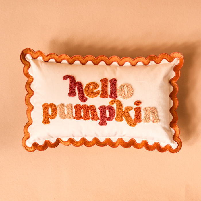 The Darling Effect Hello Pumpkin Scalloped Rectangle Throw Pillow features wavy orange trim and "hello pumpkin" embroidery in orange and red on a peach background—ideal for warming up your sofa pillow collection.