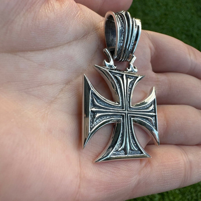Side view of sterling silver iron cross pendant highlighting thick bail for chain and solid construction