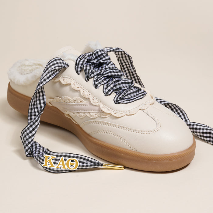The Darling Effect’s Kappa Alpha Theta Step It Up Shoelaces feature black-and-white gingham laces with gold ΚΑΘ charm tips, designed to add Greek flair to your favorite sneakers.