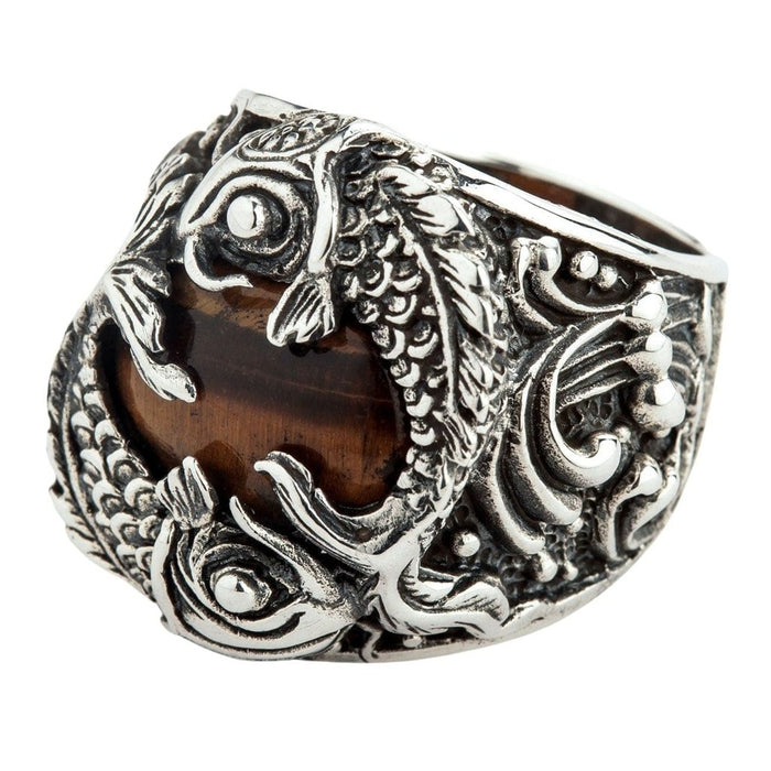 Side angle view of handcrafted Japanese koi fish ring showing intricate wave pattern and silver scrollwork