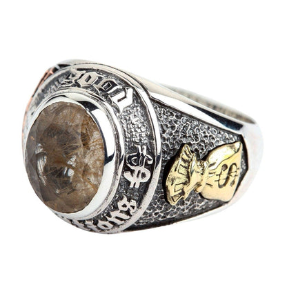 Side view of the rutilated quartz good luck ring, showing the brass money bag symbol.