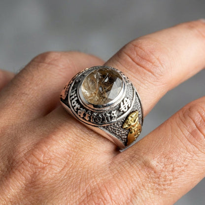 A man's hand wearing the 15-gram silver wealth ring.