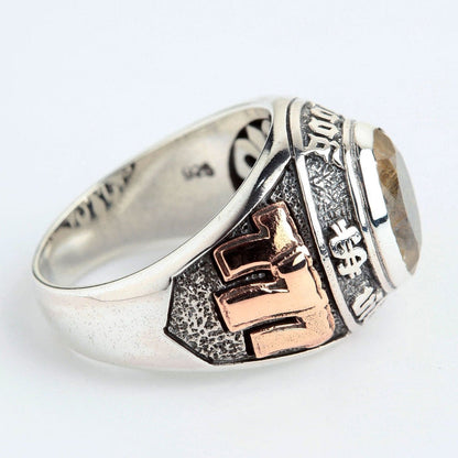 A studio shot of the two-tone lucky 777 ring with rutilated quartz on a white background.