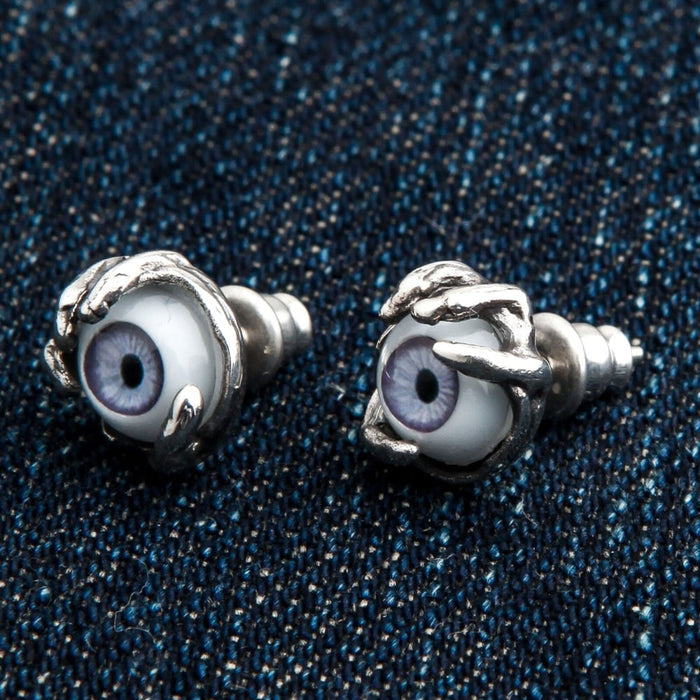 A pair of detailed creature eye stud earrings, expertly handcrafted from solid 925 sterling silver.