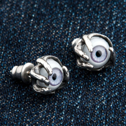 A unique pair of horror-style eyeball earrings with a monstrous, detailed claw setting, suitable for men and women.