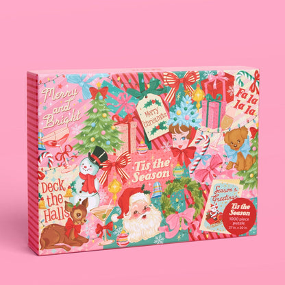 The Pinkmas | 1,000 Piece Jigsaw Puzzle by xo, Fetti features vintage Christmas art with Santa, reindeer, snowman, gifts, and festive phrases on a pink background—perfect for family fun or your next holiday puzzle challenge.