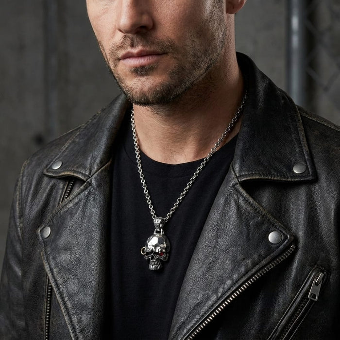 Male model in a black leather jacket wearing a silver punk skull biker pendant necklace.