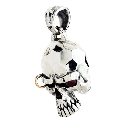 Close-up of the polished punk skull pendant, angled to reveal the red ruby CZ eye and the brow piercing ring.