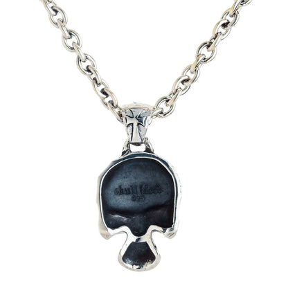 Back of the punk skull pendant showing the hollow interior, .925 hallmark, and a cross-decorated bail.