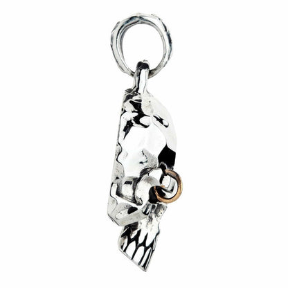Side profile of the sterling silver punk skull pendant showing the bail loop, jawline and teeth, and the brow piercing ring.
