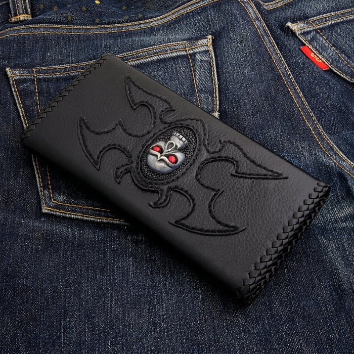 Silver-tone skull with red stone eyes mounted on an oval stingray inlay, black braided-edge biker wallet