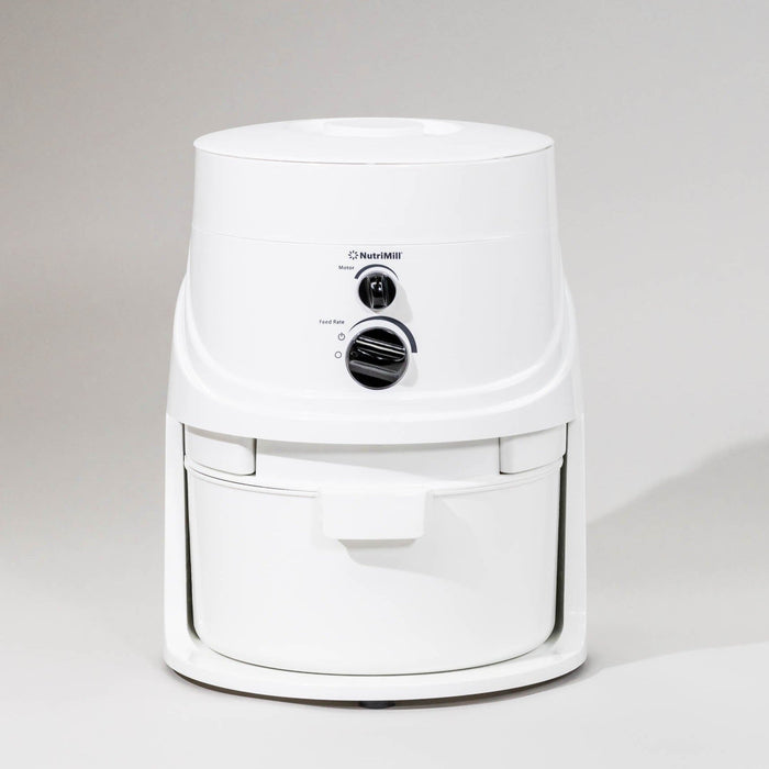 NutriMill classic grain mill on a grey background