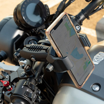 Close-up of a smartphone on a motorcycle using the RoadVise® Ultra Motorcycle Handlebar Mirror Pinch Bolt Stem Phone and Tablet Mount, displaying navigation. The motorcycle’s dashboard and controls are also partially visible.