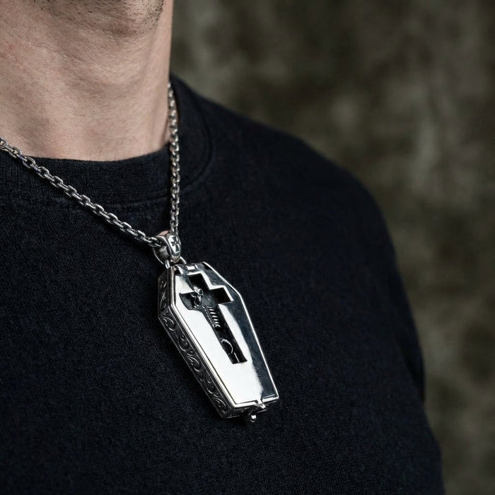 Man wearing gothic coffin pendant necklace with black sweater showing scale and styling