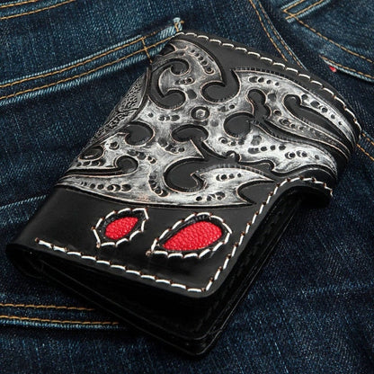 Back view of biker wallet featuring silver and black tribal flame leather carving