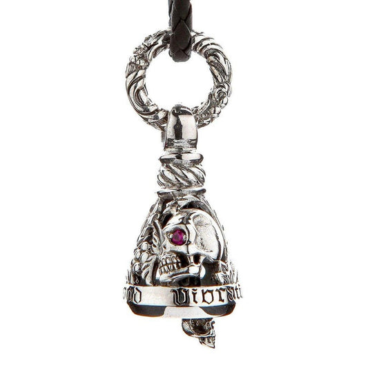 Sterling silver skull guardian bell pendant with ruby eye, gothic lettering, and ornate bail on braided leather cord