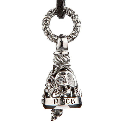 Close-up of handcrafted sterling silver biker bell showing gothic skull with diamond CZ eye, ROCK engraved banner, and ornate twisted bail ring