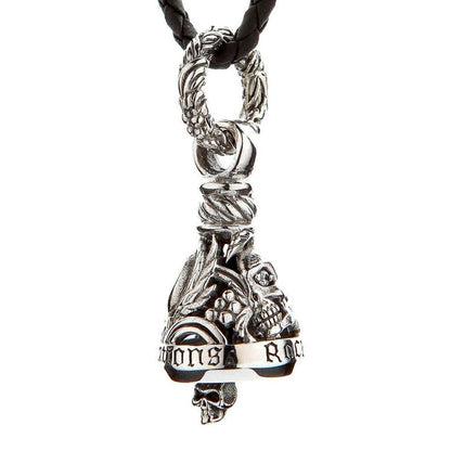 Hanging view of sterling silver gremlin bell with skull clapper, ornate leaf bail, and braided leather cord