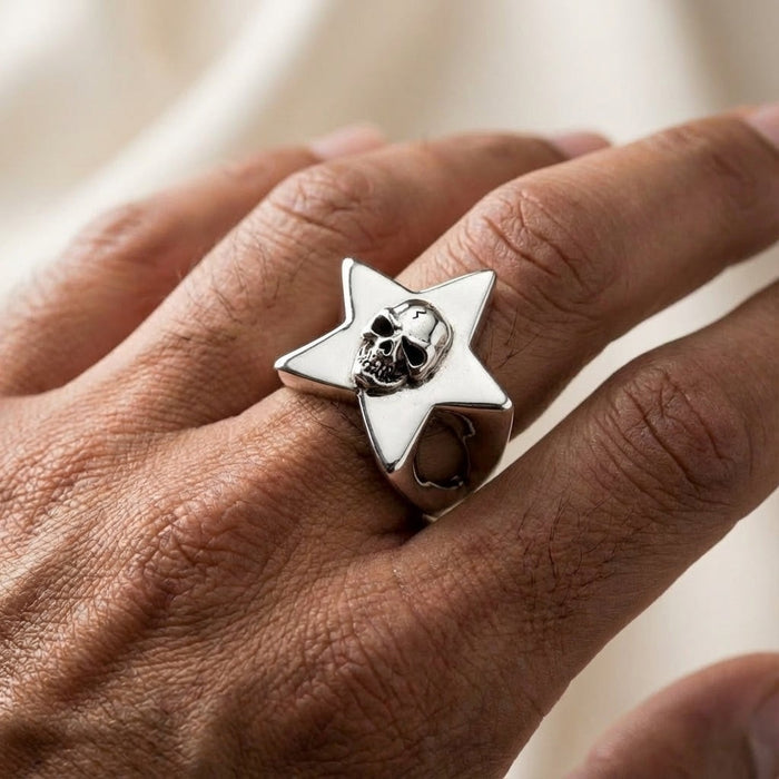 Men's skull star ring worn on finger demonstrating size and fit