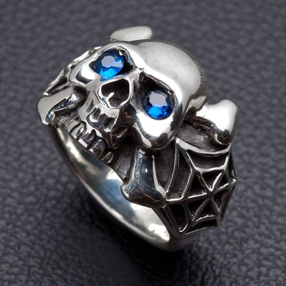 The blue eye spider skull ring, showing the crossbones.