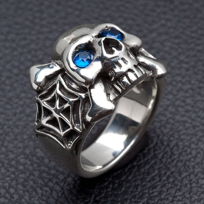 An angled view of the gothic spider skull ring, highlighting the spiderweb band.