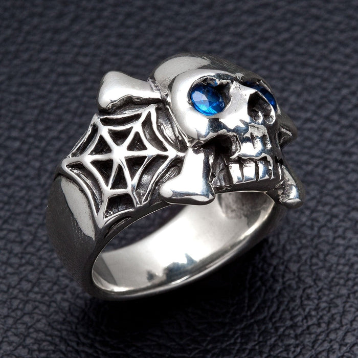 A side view of the spiderweb skull ring with blue sapphire CZ eyes.