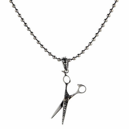 The sterling silver scissors pendant for stylists, shown hanging on a silver ball chain.