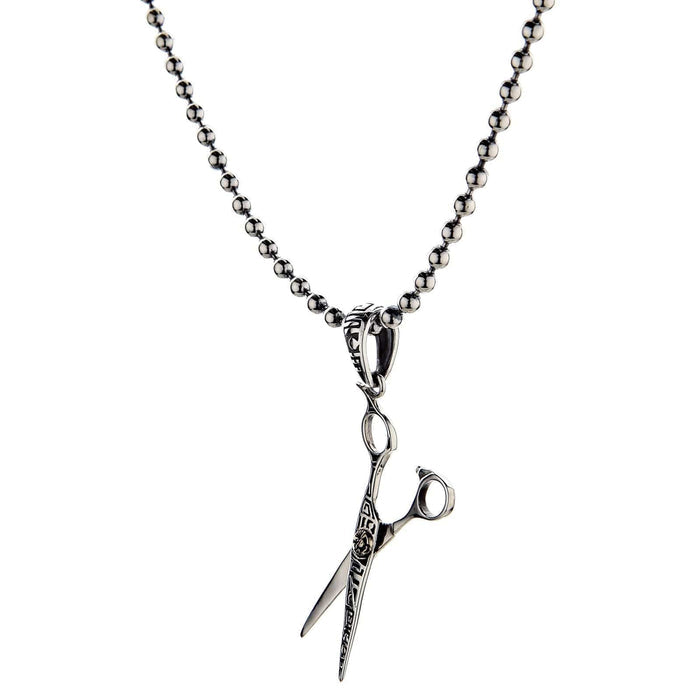 A studio shot of the sterling silver scissors pendant on a white background.