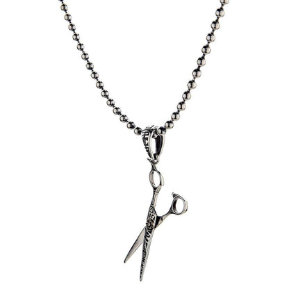 A studio shot of the sterling silver scissors pendant on a white background.