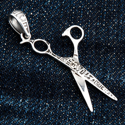 Detail of the engraved sun symbol and geometric patterns on the handcrafted barber pendant.