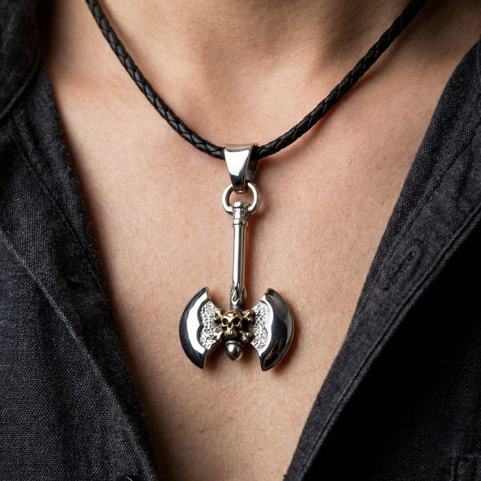 Silver Viking double-headed axe pendant with bronze skull detail on black braided leather cord necklace worn on person with gray denim shirt