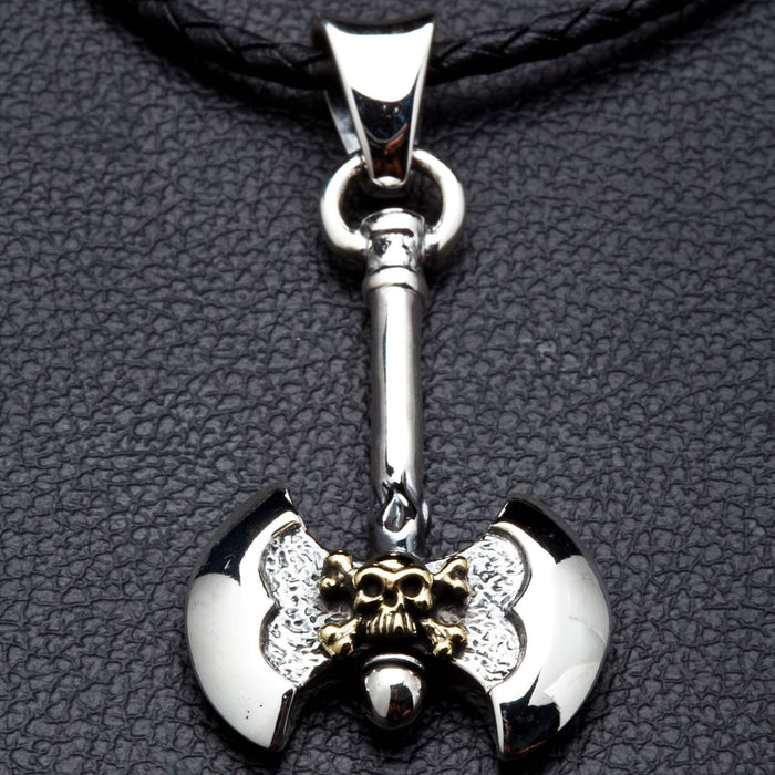 intricate brass skull on a double-bitted Viking axe pendant made from solid silver.