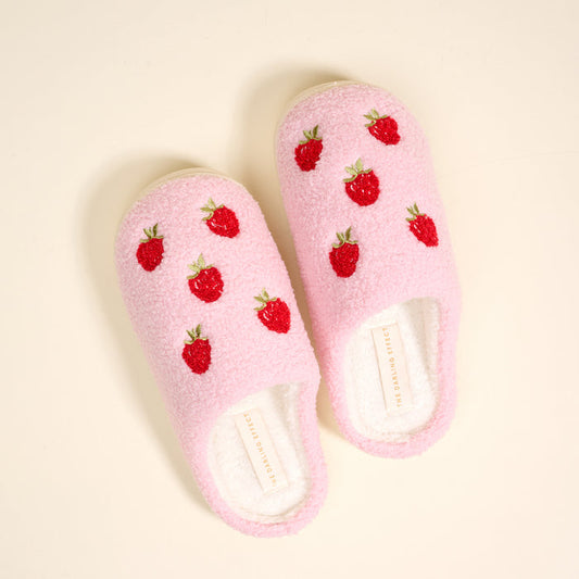 The Darling Effect’s Strawberries Fuzzy Slippers feature pink fuzz, red strawberry embroidery, and a white sole—perfect for cozy and charming lounging at home.
