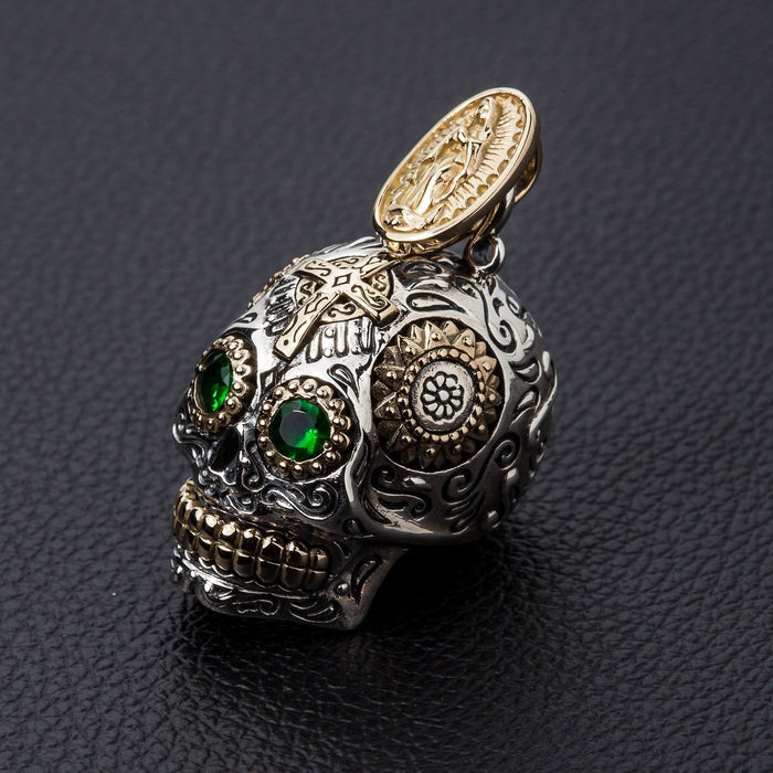 The solid 22-gram sterling silver sugar skull pendant held to show its size and substantial weight.