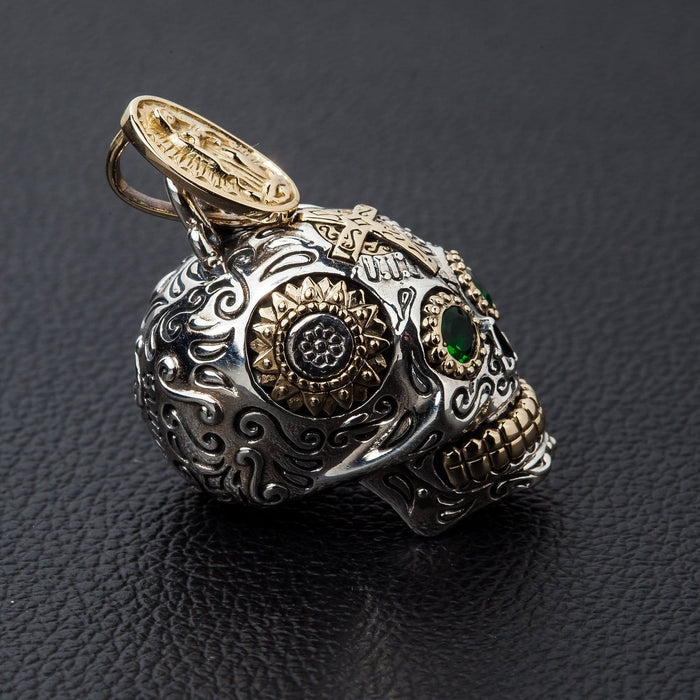 Side view of the sterling silver sugar skull pendant showing the intricate floral carvings on the temple.