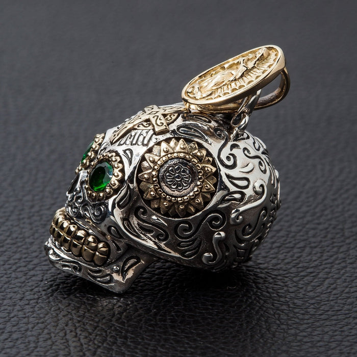 Close-up detail of the gold-plated Virgin Mary on the bail of the sterling silver sugar skull pendant.