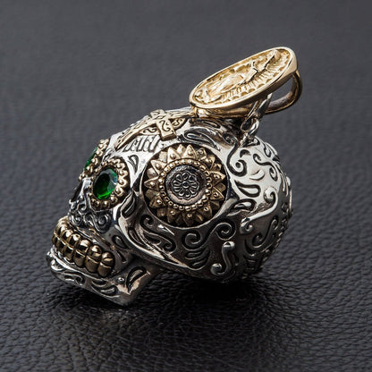 Close-up detail of the gold-plated Virgin Mary on the bail of the sterling silver sugar skull pendant.